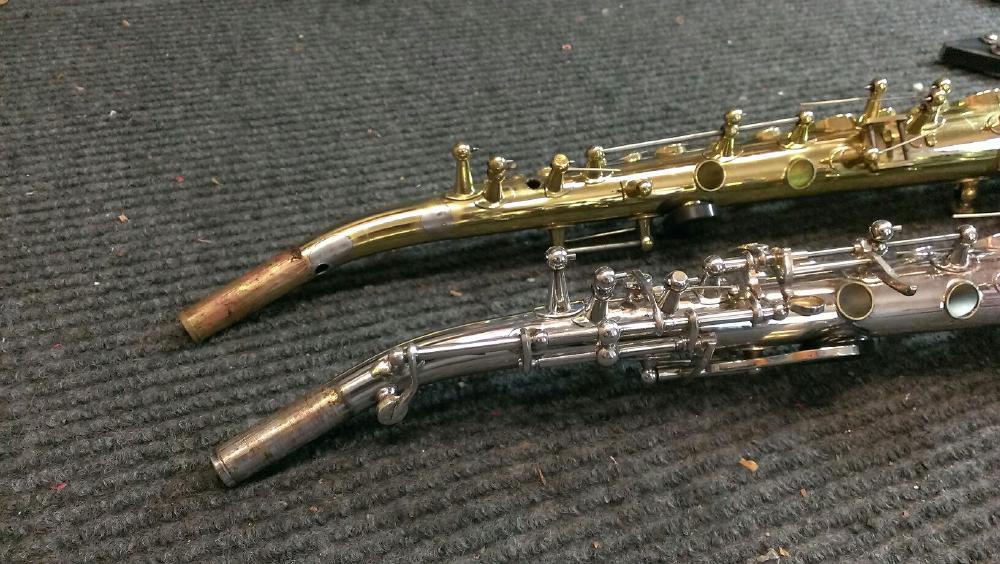 Two Yanagisawa sopranos being modified to have a one-piece bent neck.