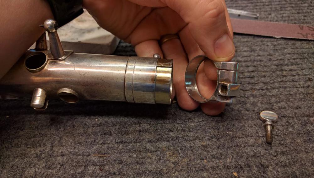 Selmer moved to a two part tenon receiver fairly early on, and the ring is attached with soft solder. It can come loose over time or when damaged, and it is possible to remove, clean up, fix, and resolder it.