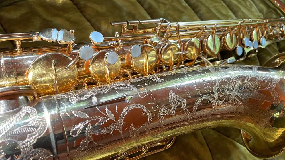 Engraving detail of gold-plated Martin Magna tenor saxophone with solid silver neck.