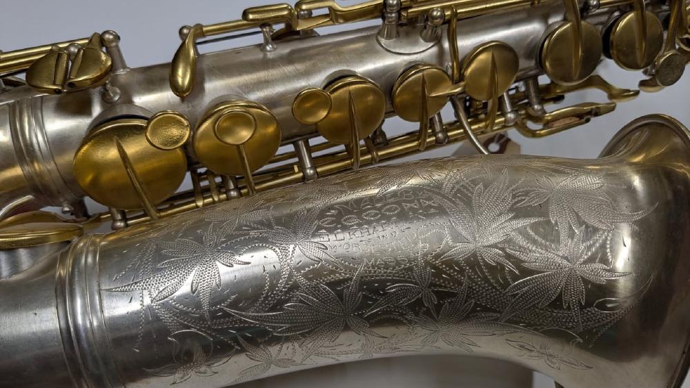 Engraving detail of one of the first saxophones built by C.G. Conn. High pitch alto, silver and gold plate with ornate engraving, 1890s.