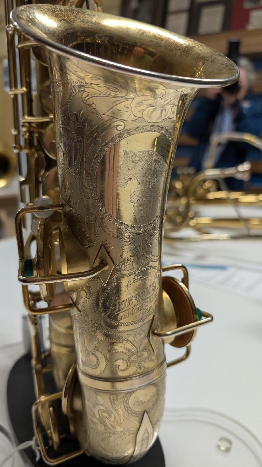 Horsies on a fully engraved Buescher.