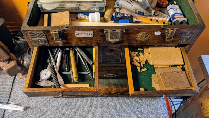 Calipers, pin vises, spring hooks, keyguard adjustment tool, tweezers, drumstick stub, pad irons, assorted natural and synthetic corks