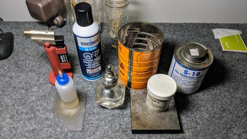 Key oil, torch, butane, lapping compound, alcohol lamp, assorted sandpapers, contact cement, bench block